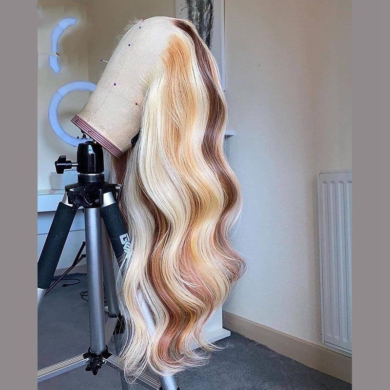 Beautiful brown blonde human hair wig displayed on a stand with wavy texture and highlights