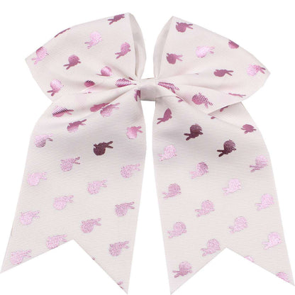Children's rainbow hair accessories with a large pink bow featuring heart patterns