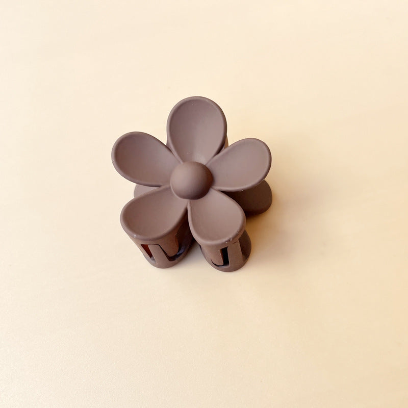 Summer candy color frosted colorful flower hair clip with six petals on beige background