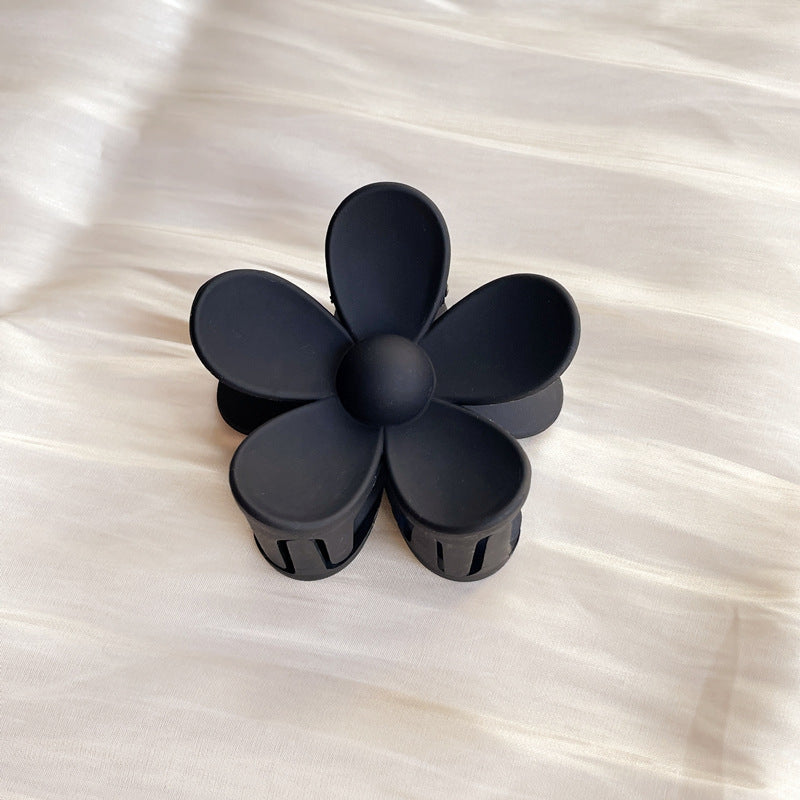 Black colorful flower hair clip with frosted finish shaped like a five-petal flower