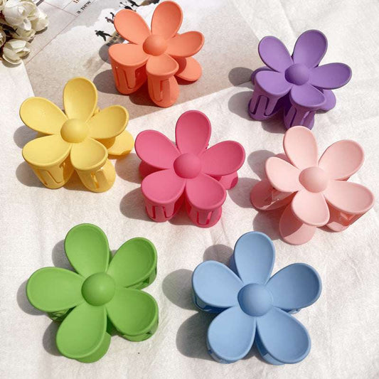 Set of colorful flower hair clips in pastel shades including yellow, pink, orange, purple, green, blue, and light pink