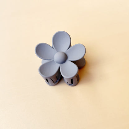 Pastel purple colorful flower hair clip with frosted finish on beige background