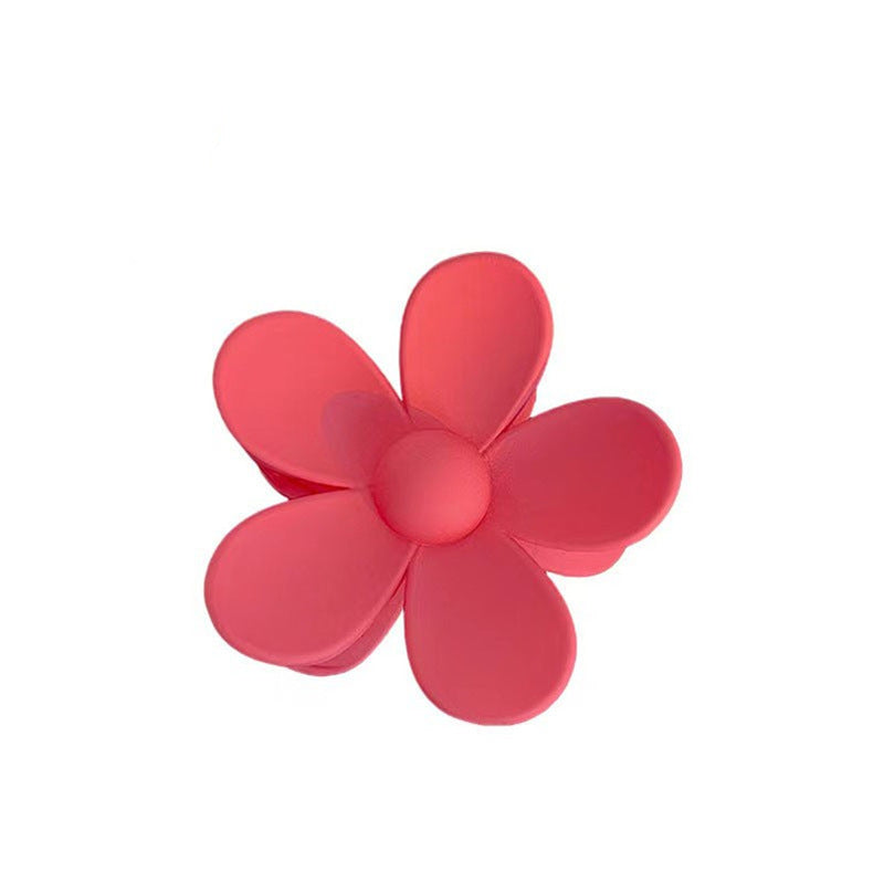 Pink colorful flower hair clip with frosted petals in a candy color summer style