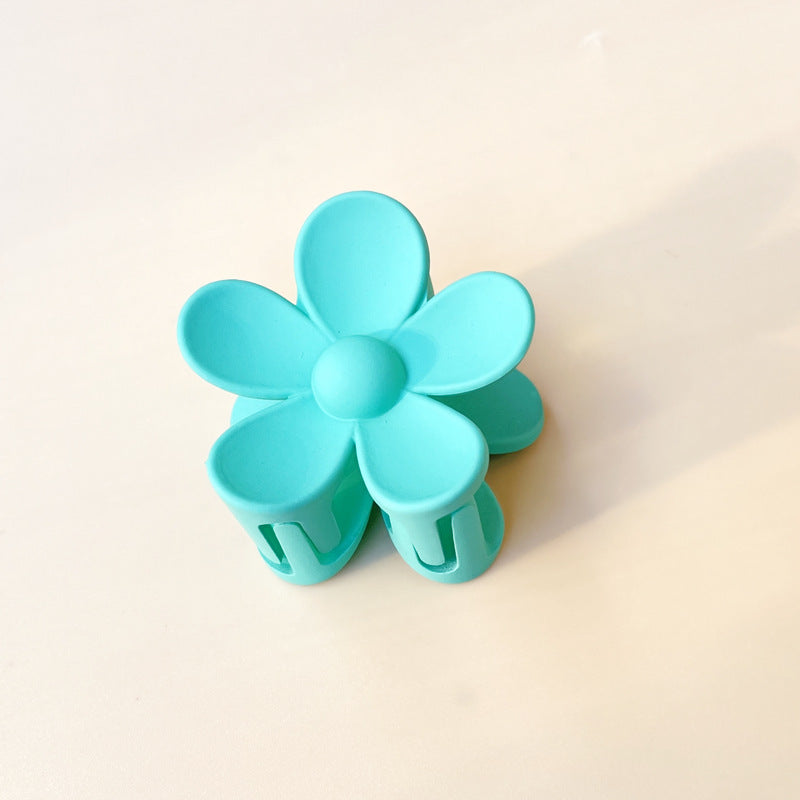 Blue colorful flower hair clip with frosted finish and petal design for summer style