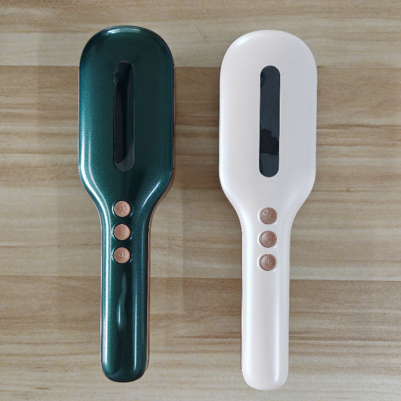Electric massage hair comb in green and white with control buttons for household relaxation