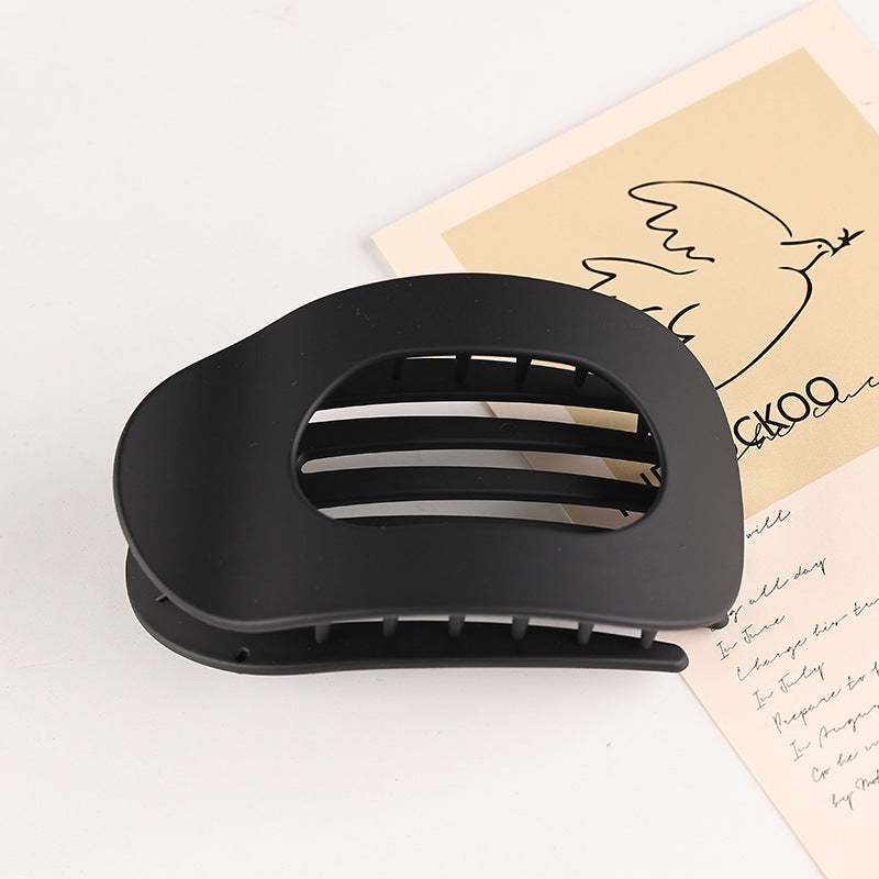 Black flat oval hair barrette with open slats for back head updo styling
