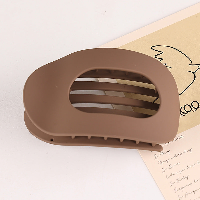 Brown flat oval hair barrette with open design for back head updo hairstyles