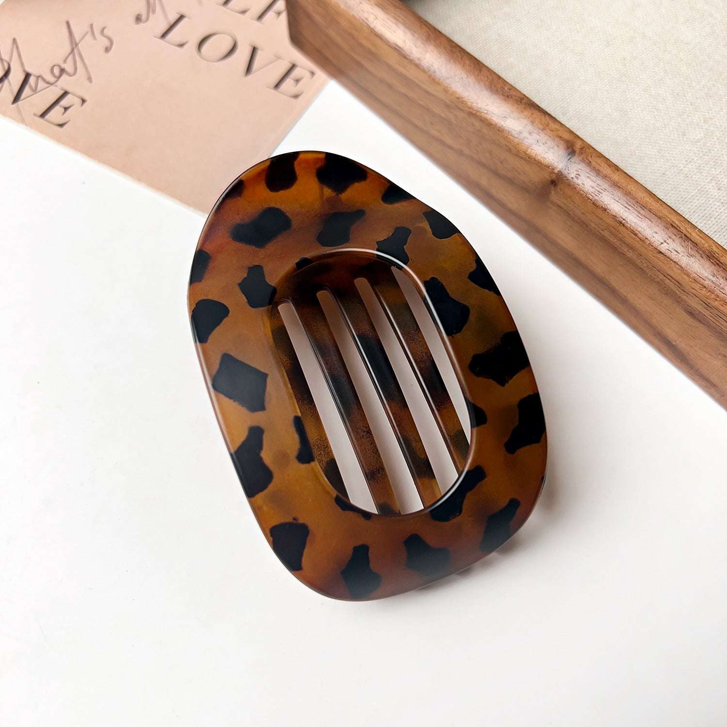 Flat oval hair barrette with tortoiseshell pattern for back head updo styling