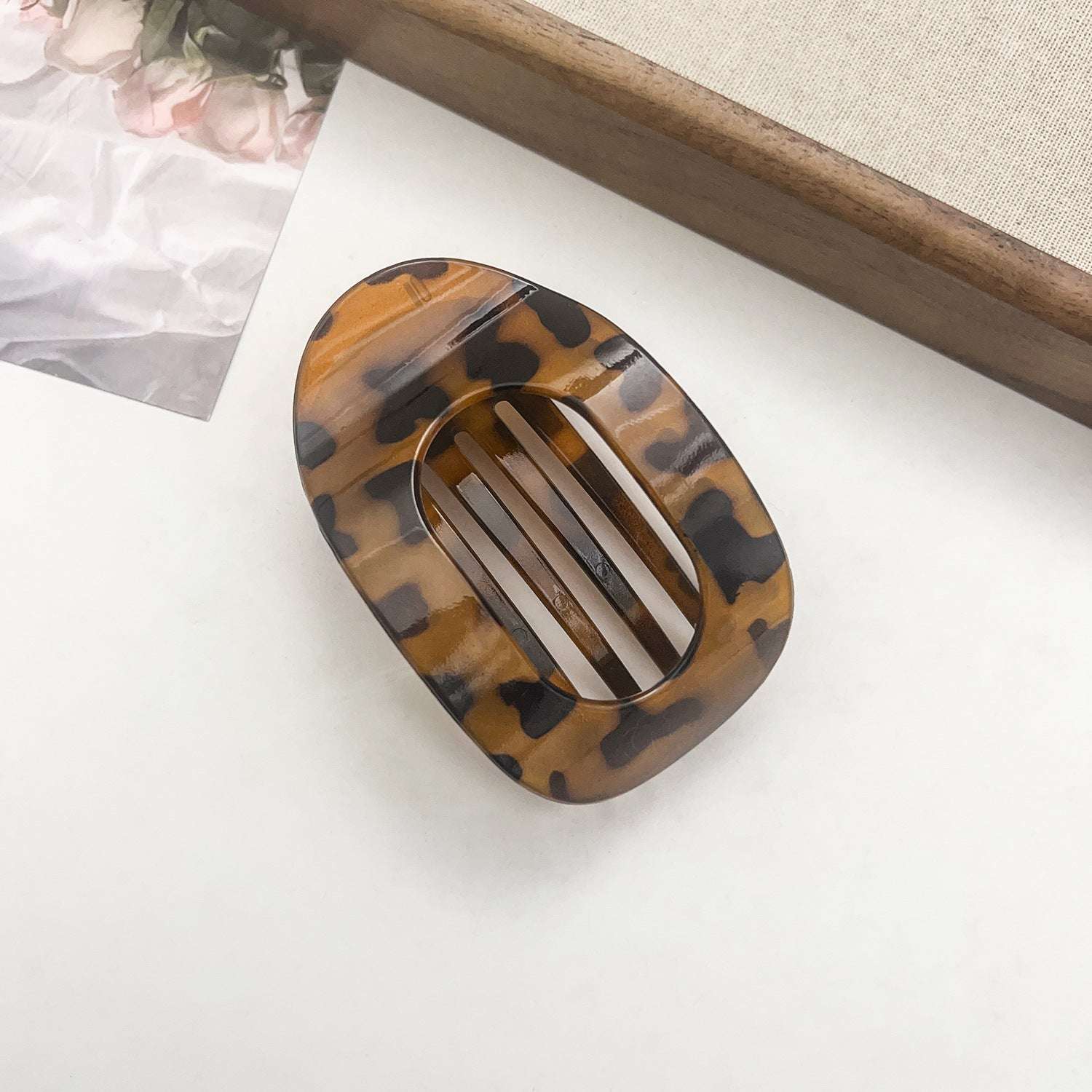 Tortoiseshell flat oval hair barrette with black and brown pattern for back head updo styles