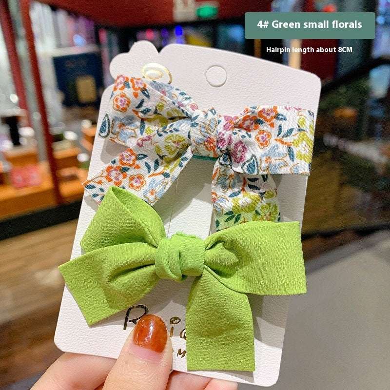 Luxury children's hairclips set featuring green bow and floral fabric barrettes for girls