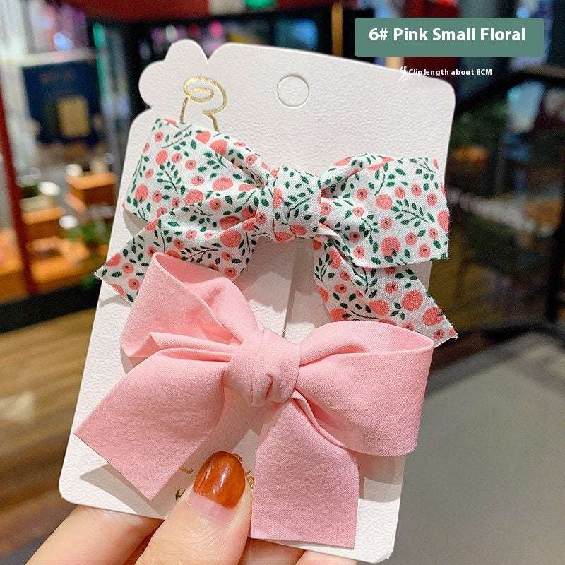 Luxury children's hairclips featuring pink and floral bow designs for stylish girls