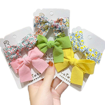 Set of four luxury children's hairclips in floral and bow designs for stylish girls