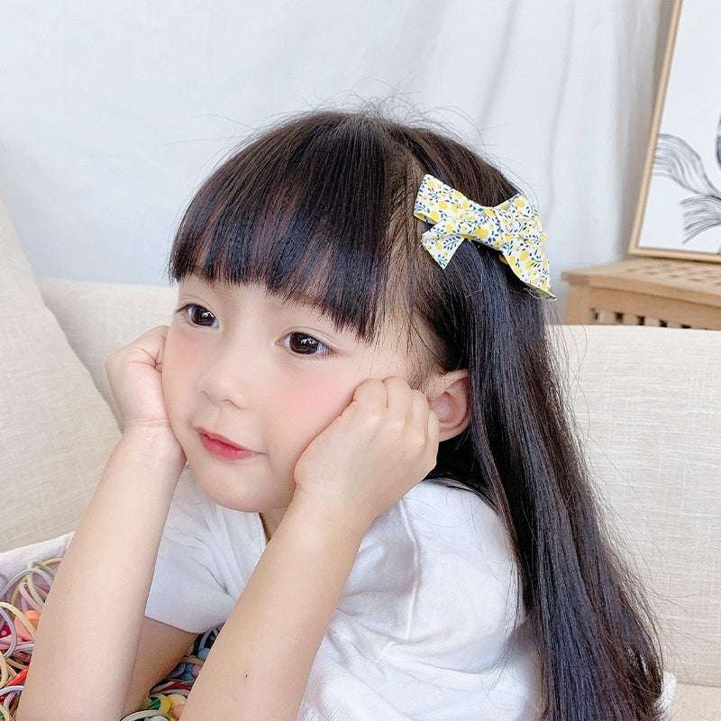 Luxury children's hairclips featuring a bow design in floral fabric for girls
