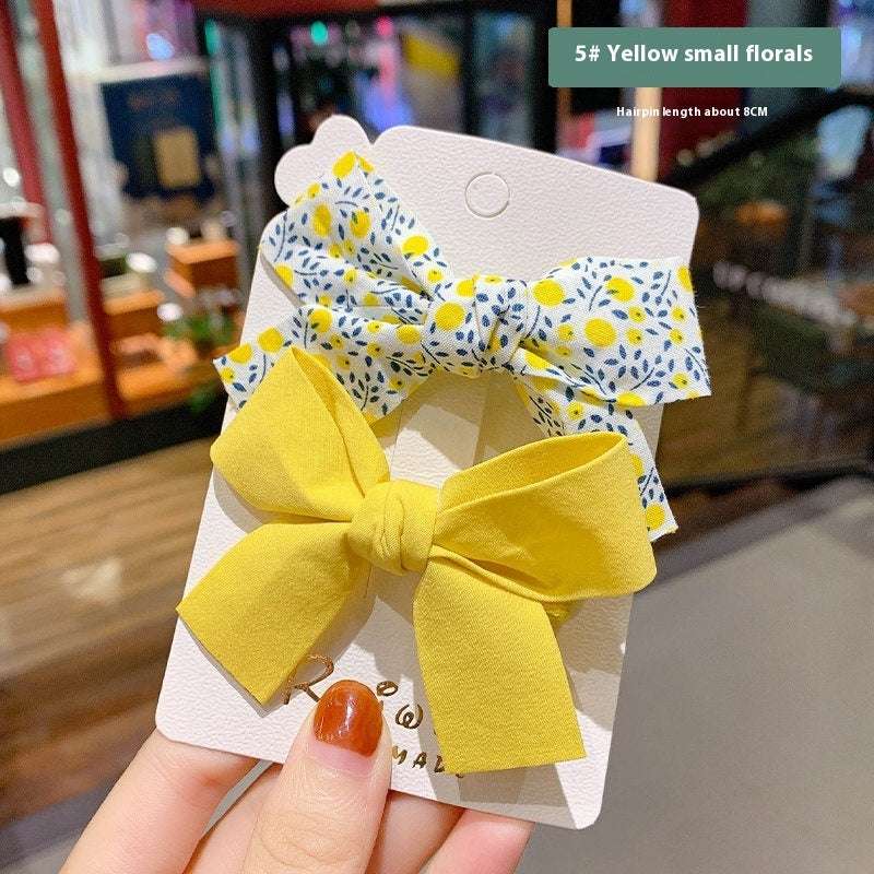 Luxury children's hairclips featuring yellow and floral bow barrettes for stylish girls