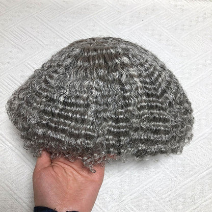 Men's real human hair toupee with soft, wavy texture held in hand for easy styling and natural look