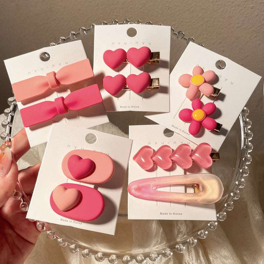 Colorful heart-shaped hairclip set with various designs including bow and flower shapes