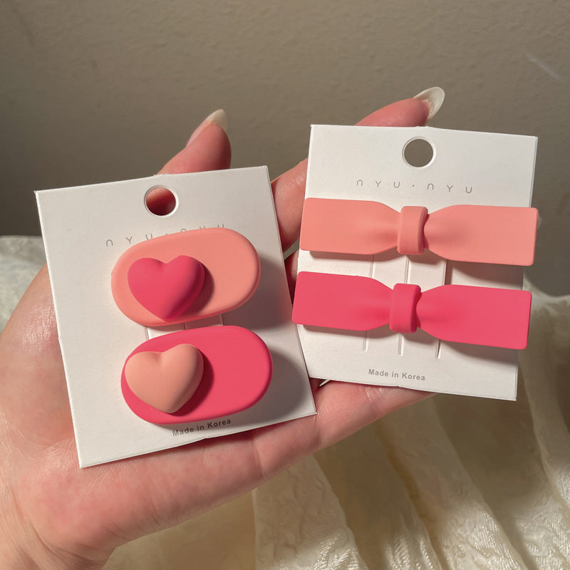 Heart-shaped hairclip set in pink and red colors for stylish hair accessories