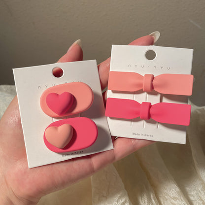 Heart-shaped hairclip set in pink and red colors for stylish hair accessories