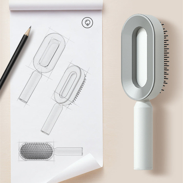 Concept design sketch and one-key cleaning hairbrush on a workspace with pencil