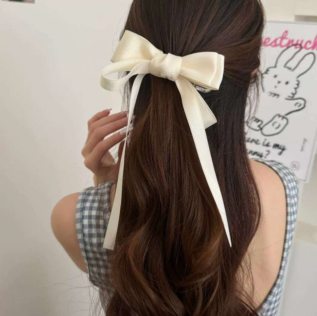 Elegant women's hairstyle featuring premium French barrettes for women with a large bow accent