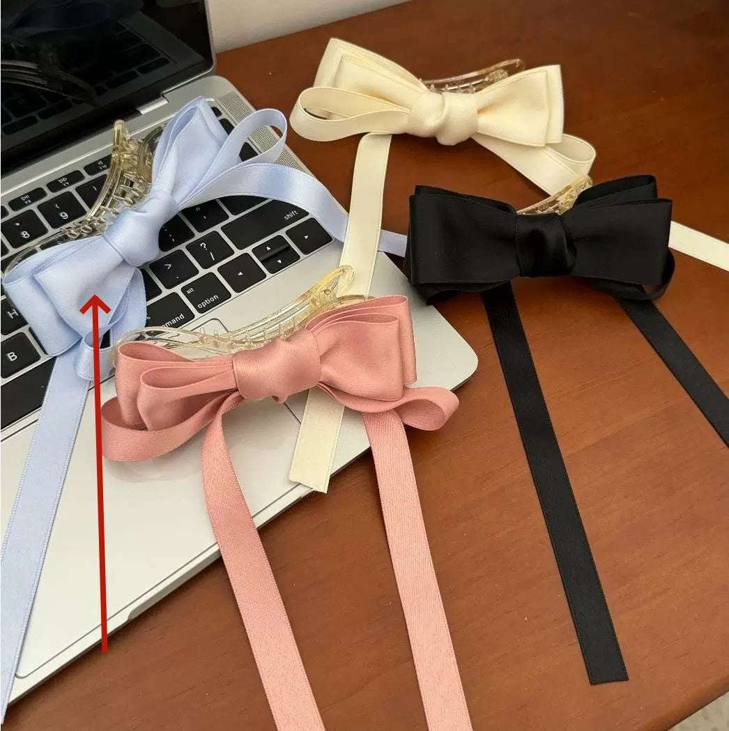 Set of premium French barrettes for women in pastel colors with elegant ribbons on a table