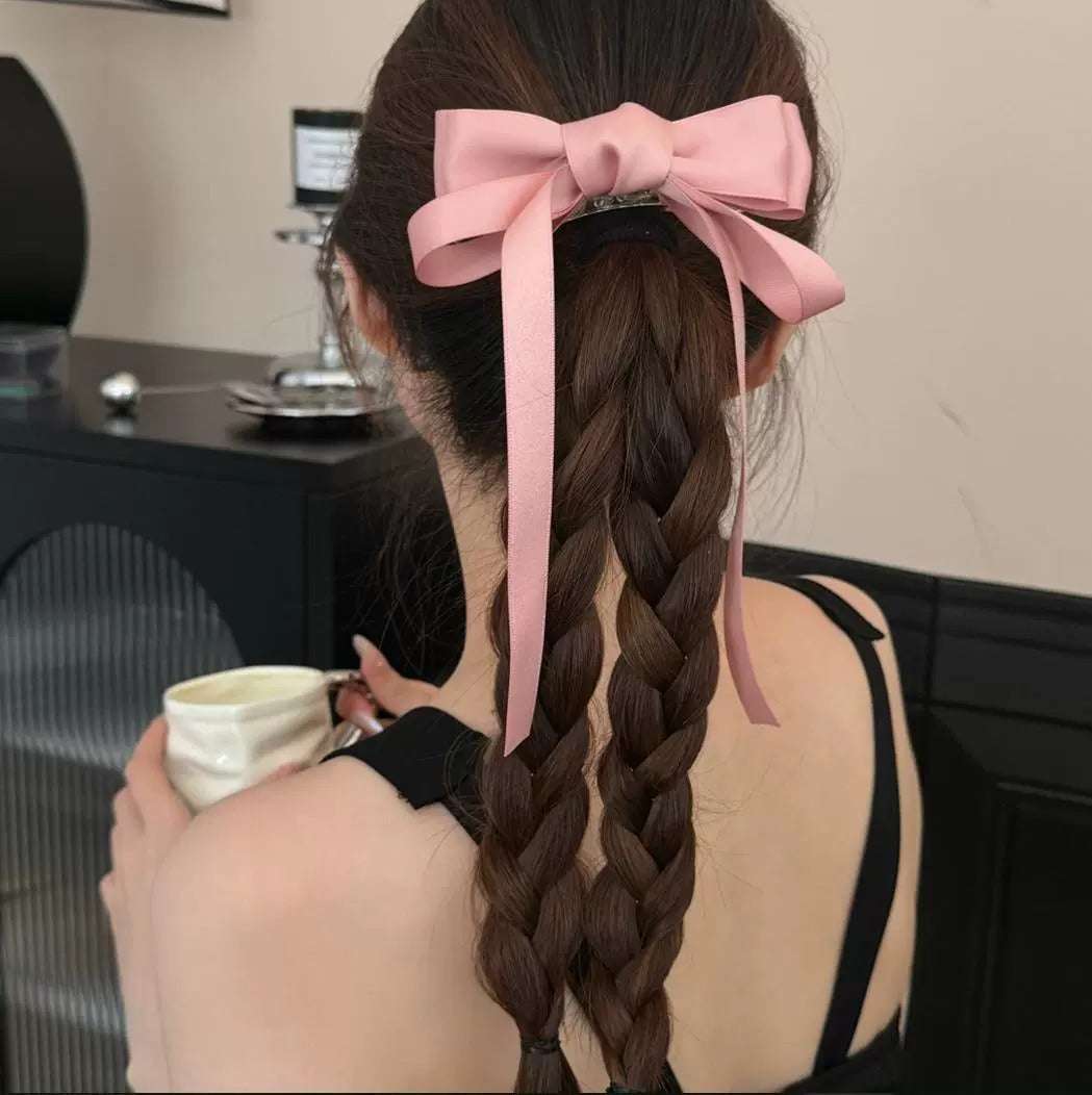 Elegant women's hairstyle featuring premium French barrettes for women with a pink bow accent