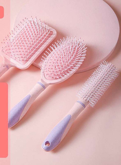 Set of three pink hair brushes including a professional airbag comb with ergonomic handles for personal wash