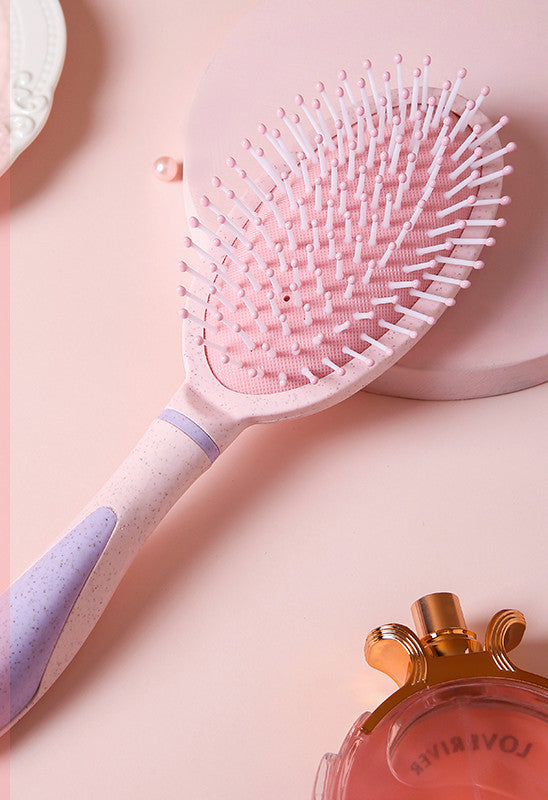 Pink professional airbag comb with soft bristles designed for gentle detangling and personal care