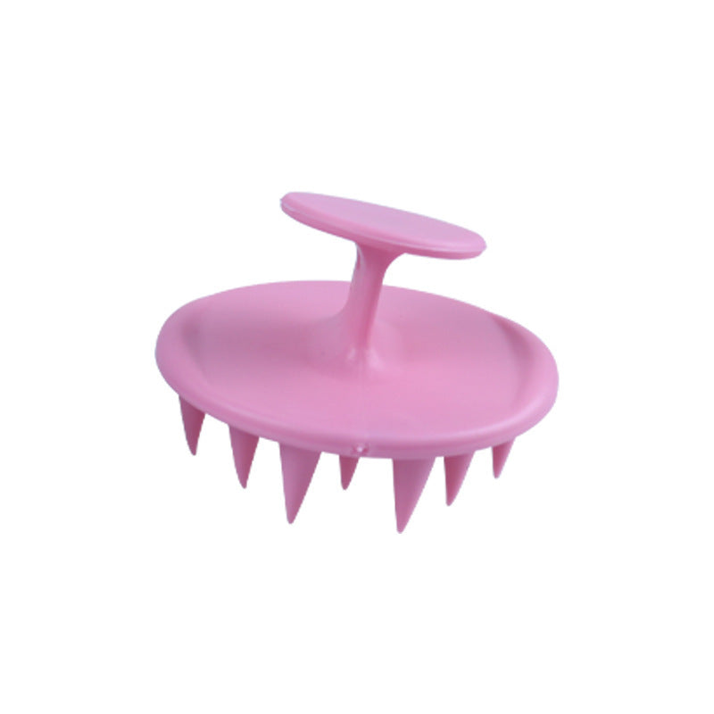 Pink silicone shampoo brush with soft bristles for effective scalp massage and cleaning