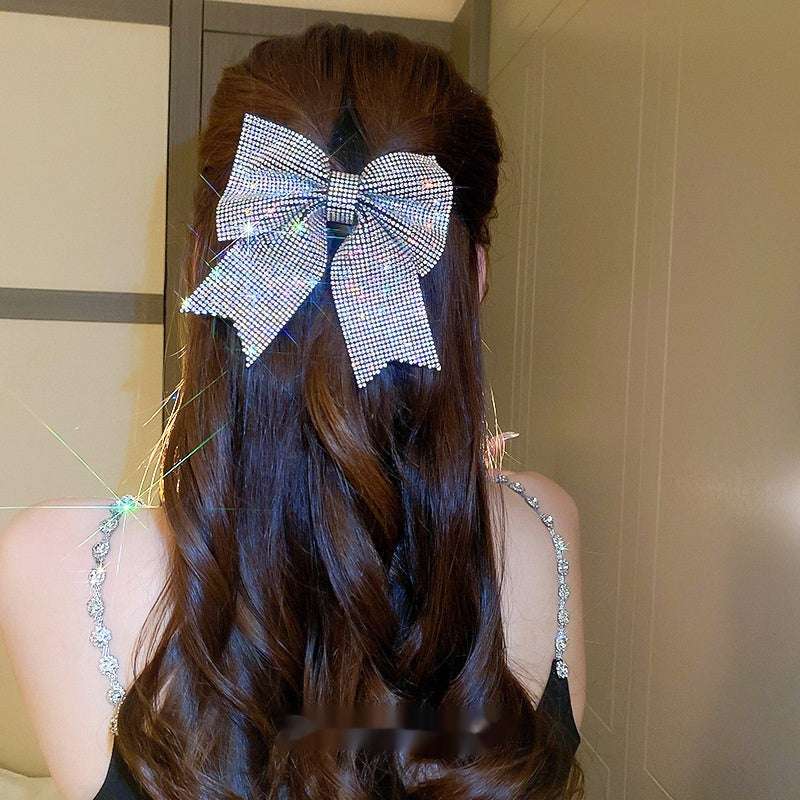 Back Shape Mosquito Coil TT Comb Hair St with a sparkling hair clip in a bow design
