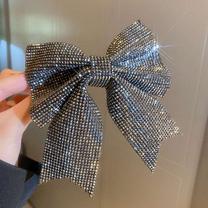 Sparkling hair clip with a large bow design made of shiny rhinestones for a glamorous look