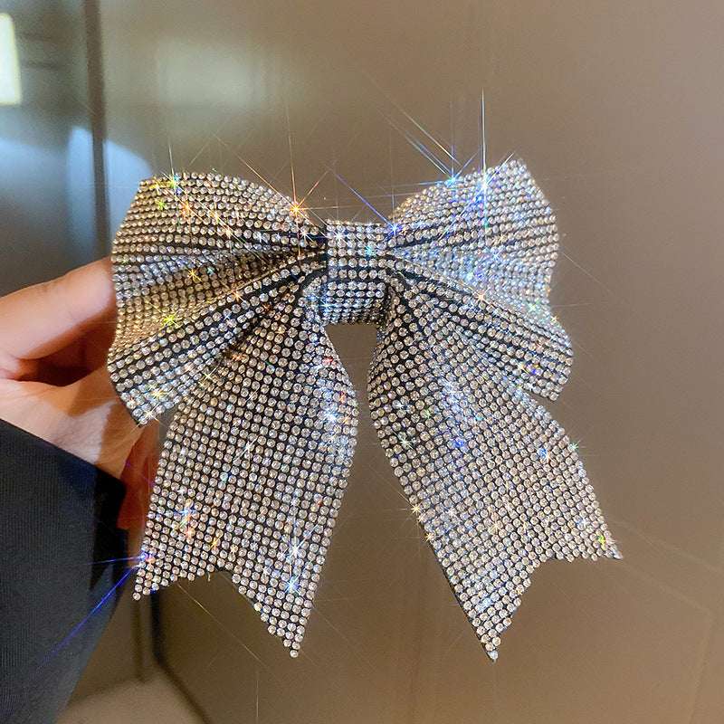 Sparkling hair clip in bow shape adorned with glittering rhinestones for a stylish look