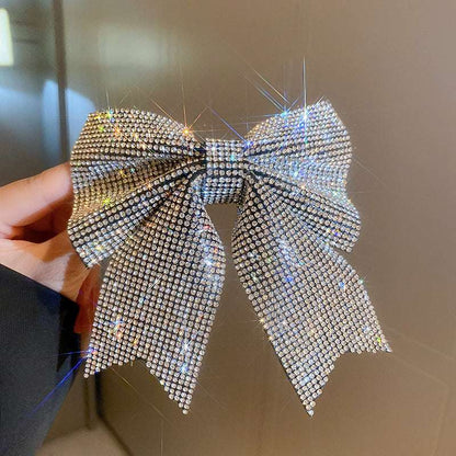 Sparkling hair clip in bow shape adorned with glittering rhinestones for a stylish look