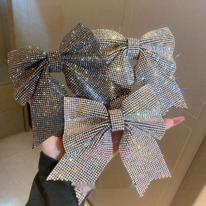 Set of sparkling hair clips in bow shapes with rhinestone details for stylish hairstyles