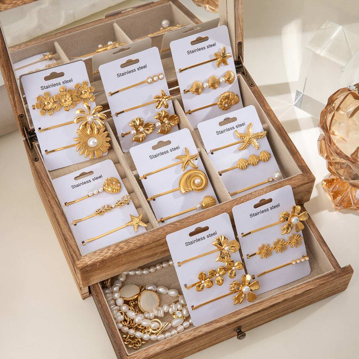 Collection of gold lady's flower titanium steel hair barrettes displayed in a wooden jewelry box