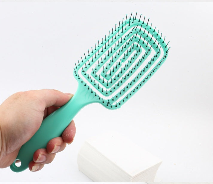 TT hair styling comb in turquoise, designed for detangling hair with a unique grid pattern