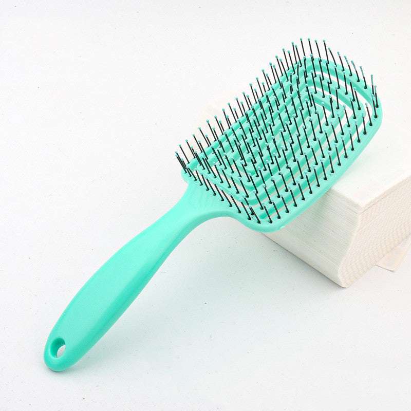 TT hair styling comb in mint green color with metal bristles for effective hair detangling