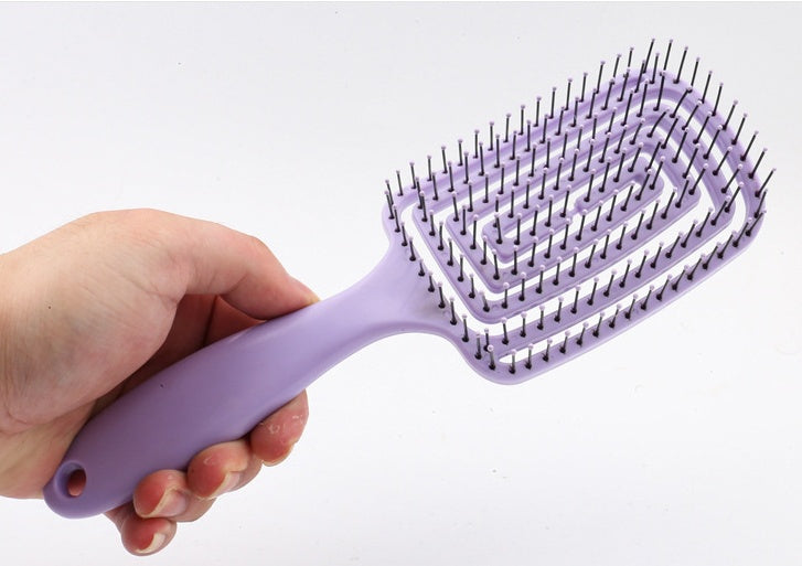 TT hair styling comb in purple with a unique back shape for effective hair styling and detangling