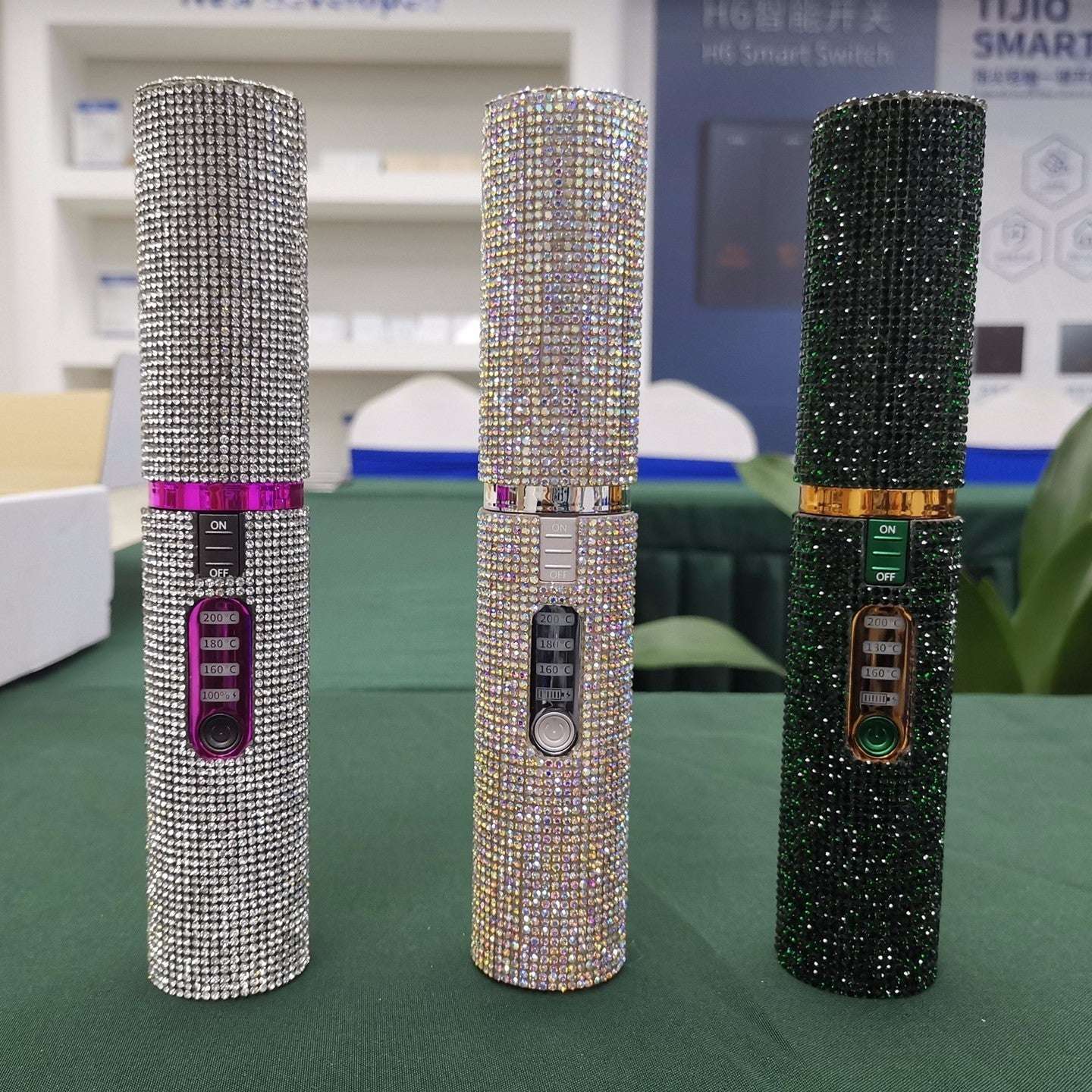 Three glittery USB hair straightener for travel in silver, gold, and black with control buttons